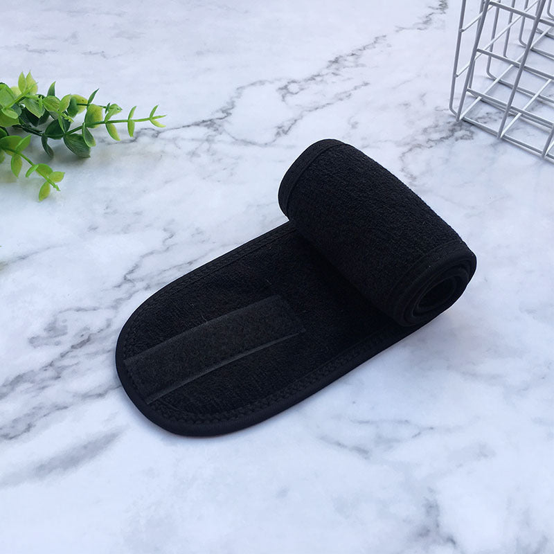 Black beauty headbands for women made of soft fabric with adjustable fastening on marble surface