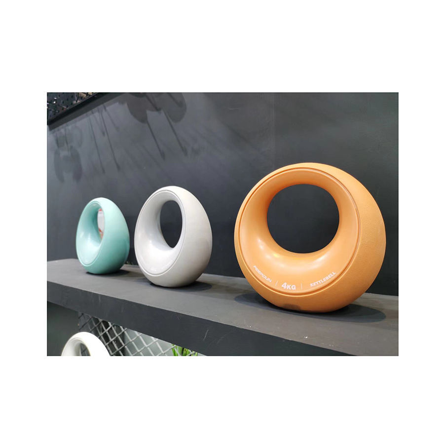 Set of colorful women's fitness dumbbells with a modern circular design displayed on a shelf