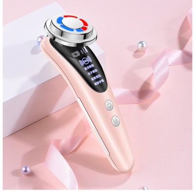 Pink electric facial cleansing brush with digital display and multifunction buttons on a pink background