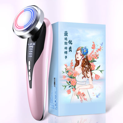 Pink electric facial cleansing brush with LED light next to floral design packaging box