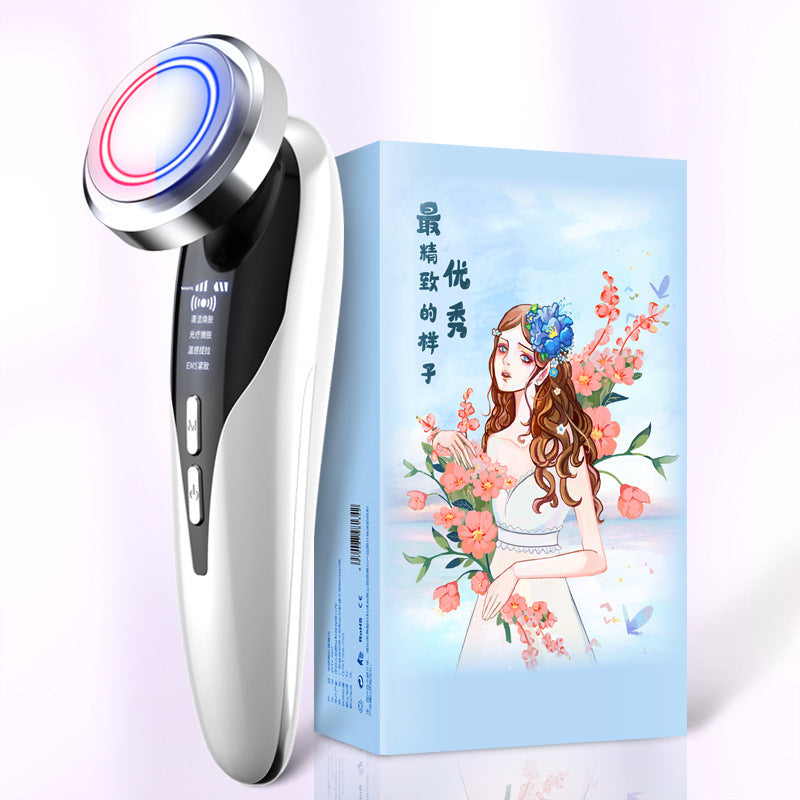 Electric facial cleansing brush with LED light and sleek white design next to decorative blue box with floral artwork