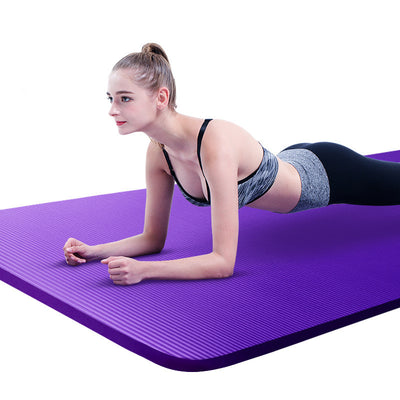 Woman doing plank exercise on a purple fitness mat for home workouts for core strength