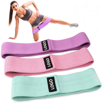 Fitness resistance loop for squats in purple, pink, and mint green with woman demonstrating exercise