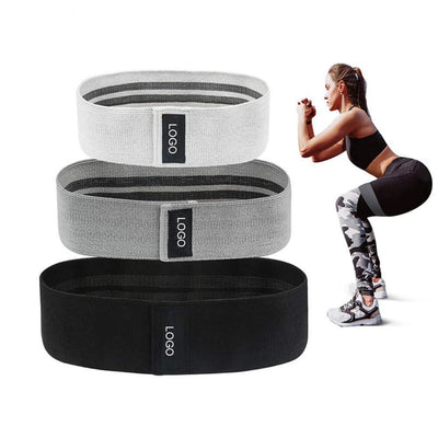 Fitness resistance loop for squats in white gray and black with woman performing squat exercise