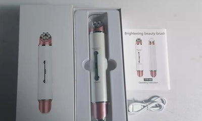Heated eye massager with brightening beauty brush and USB charging cable in white and rose gold