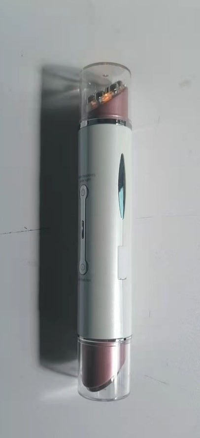 Compact heated eye massager device in white and rose gold with transparent end caps