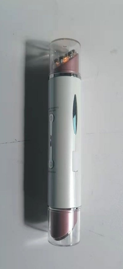 Compact heated eye massager device in white and rose gold with transparent end caps