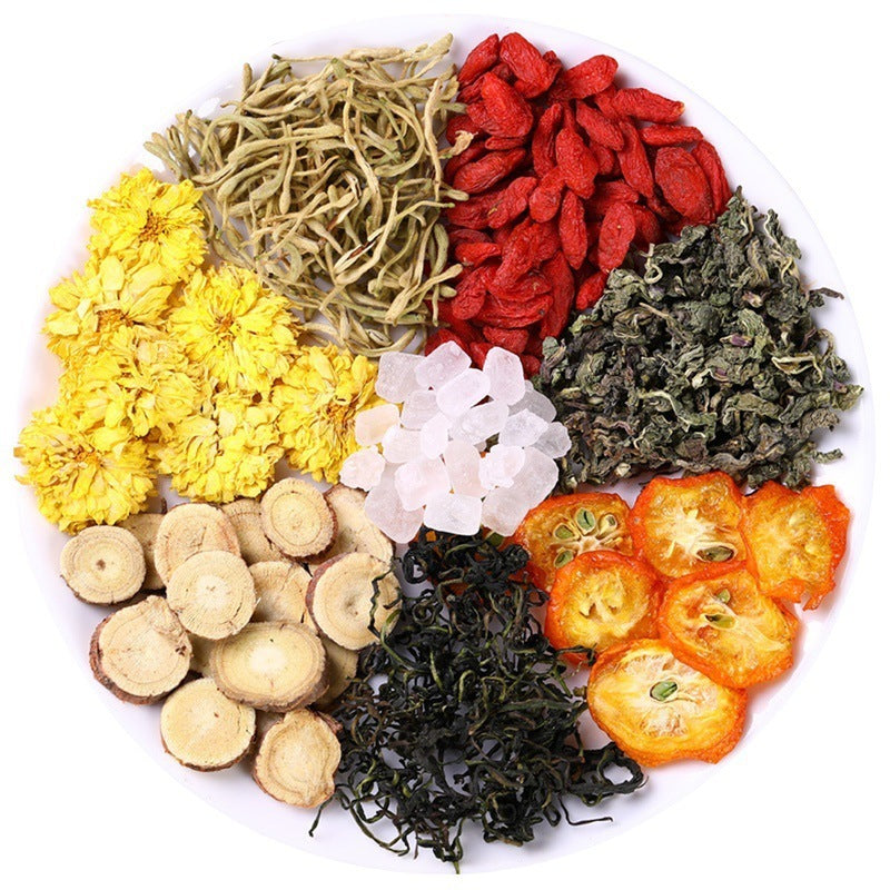 Assorted dried herbs and flowers arranged on a plate for honeysuckle chrysanthemum tea blend