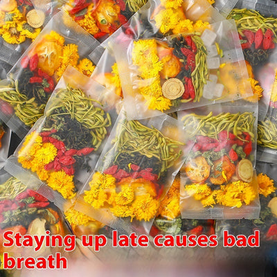 Packets of honeysuckle chrysanthemum tea with dried flowers and herbs in clear packaging