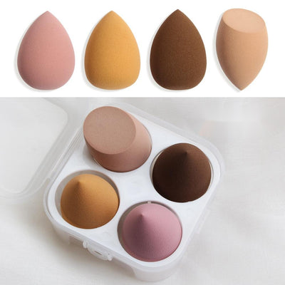 Set of four colorful spherical makeup sponge in a white travel case for flawless makeup application