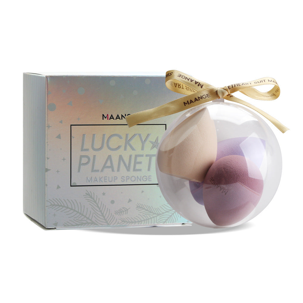 Spherical makeup sponge set in clear round case with decorative ribbon and Lucky Planet packaging