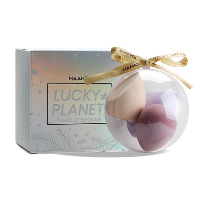 Spherical makeup sponge set in clear round case with decorative ribbon and Lucky Planet packaging