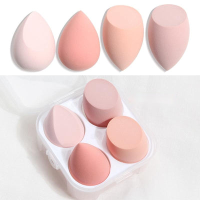 Set of four different shaped pink and peach spherical makeup sponge applicators in a clear plastic case