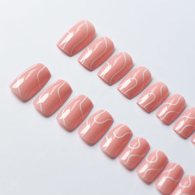 Pink press on nails for women with white abstract line design in glossy finish