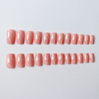 Set of peach press on nails for women with white abstract line designs in two rows