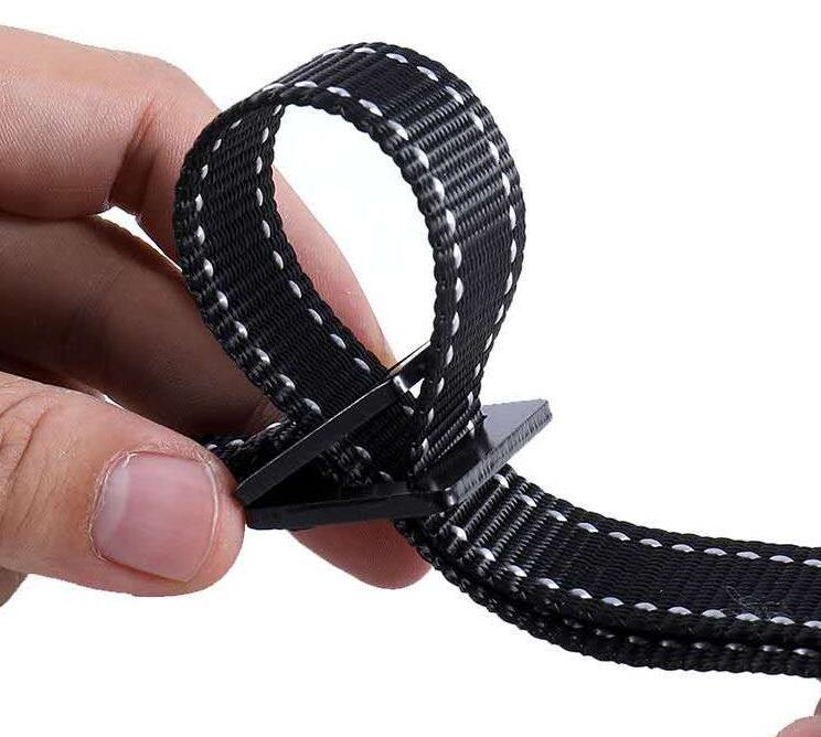 Close-up of black strap being adjusted as part of ring fitness equipment for home use
