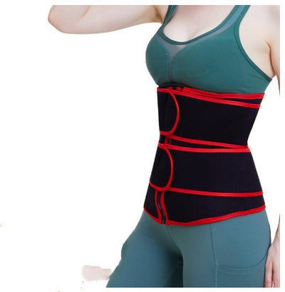 Woman wearing black and red waist slimming sweat belt over green workout clothes