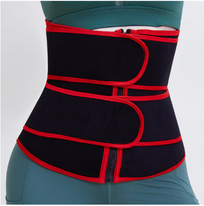 Black and red waist slimming sweat belt worn over teal workout clothes for core support