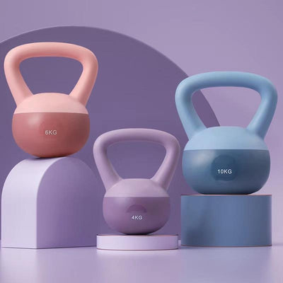Set of colorful women's kettlebell for home workouts in 4kg 6kg and 10kg weights on pastel stands