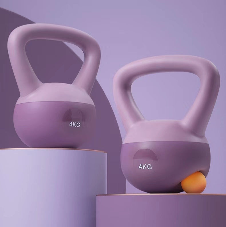 Purple 4kg women's kettlebell for home workouts displayed on pastel purple podiums